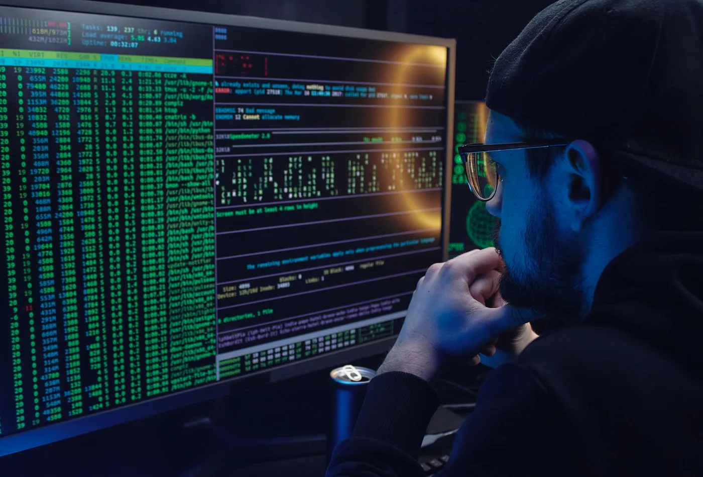 An engineer monitoring systems across two screens